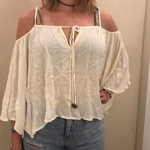 White flowy shoulder showing crop top